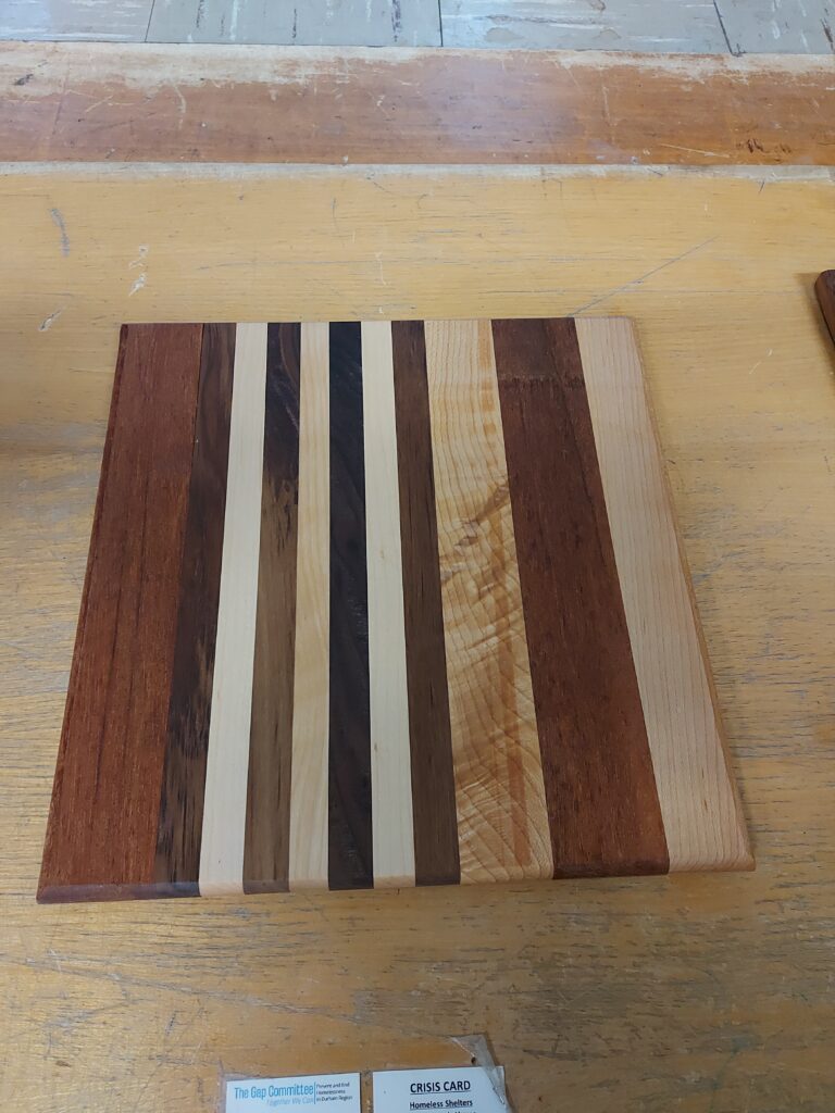 Maple, walnut and mahogany cutting board by Steve Hutcheon. Finished with that oil your give to animals to help them go crappie. (Castor Oil)